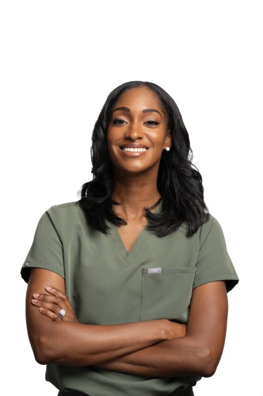 Meet the Dentist at Elevated Oasis Dental Dentist in green scrubs welcoming patients to Elevated Oasis Dental in Mitchellville, MD